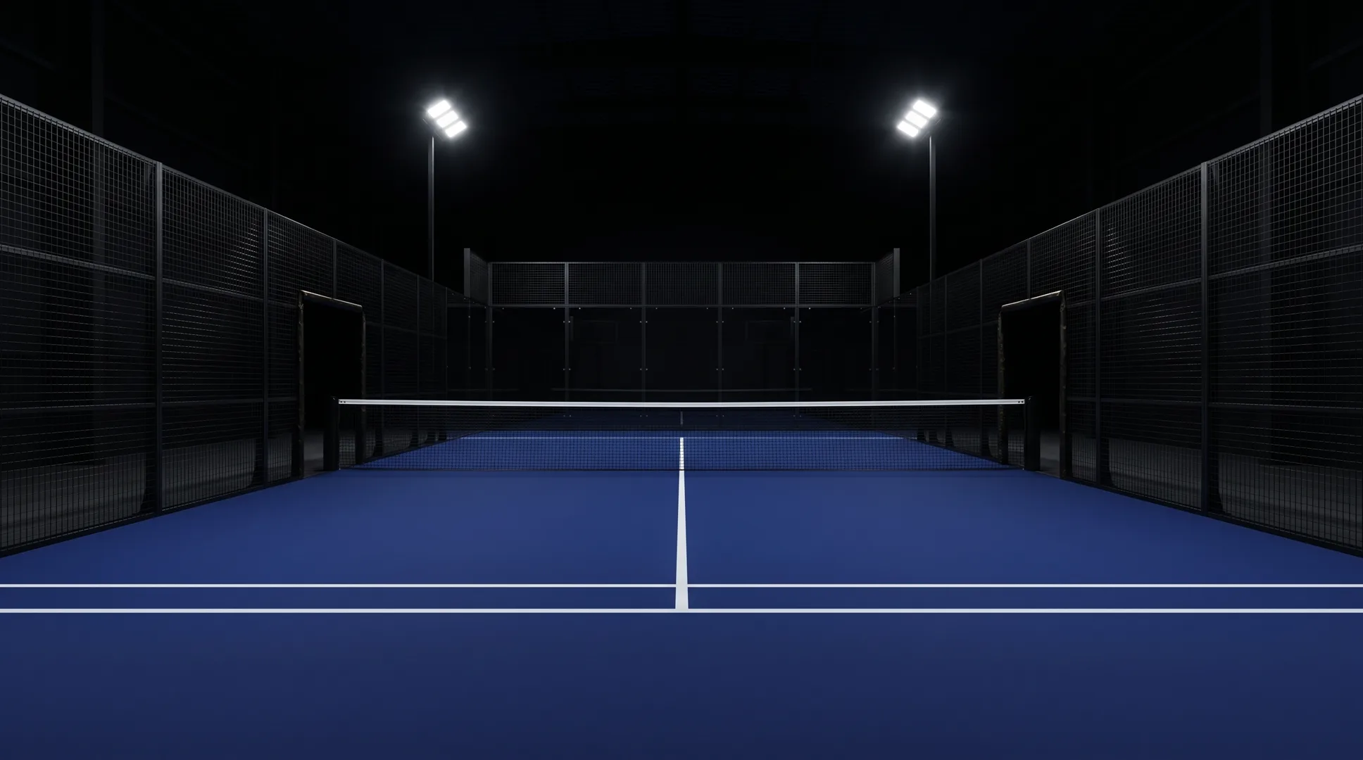 The navy padel court under floodlights, seen from the baseline.